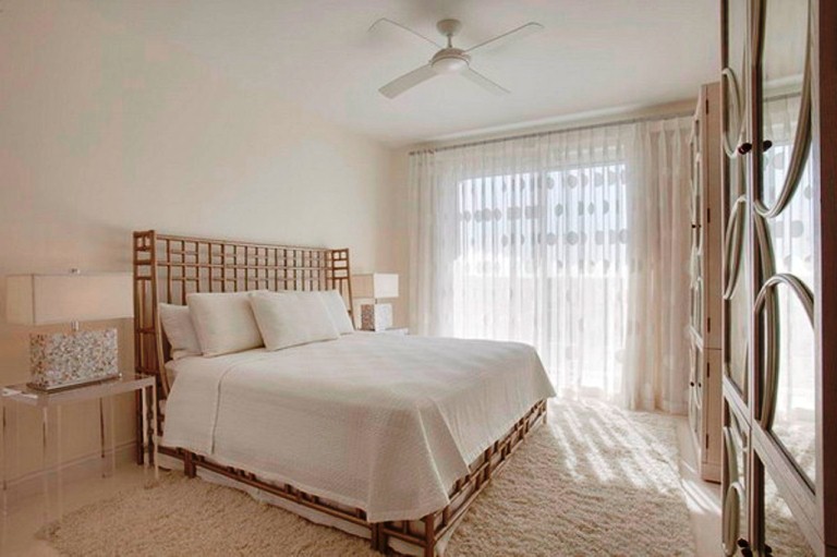 Нежная белая спальня с кремовыми оттенками и люстрой в виде вентилятора