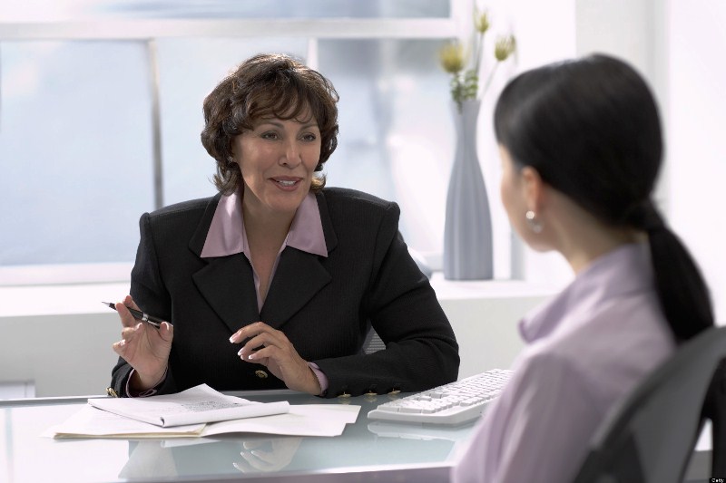 Mature businesswoman talking to colleague